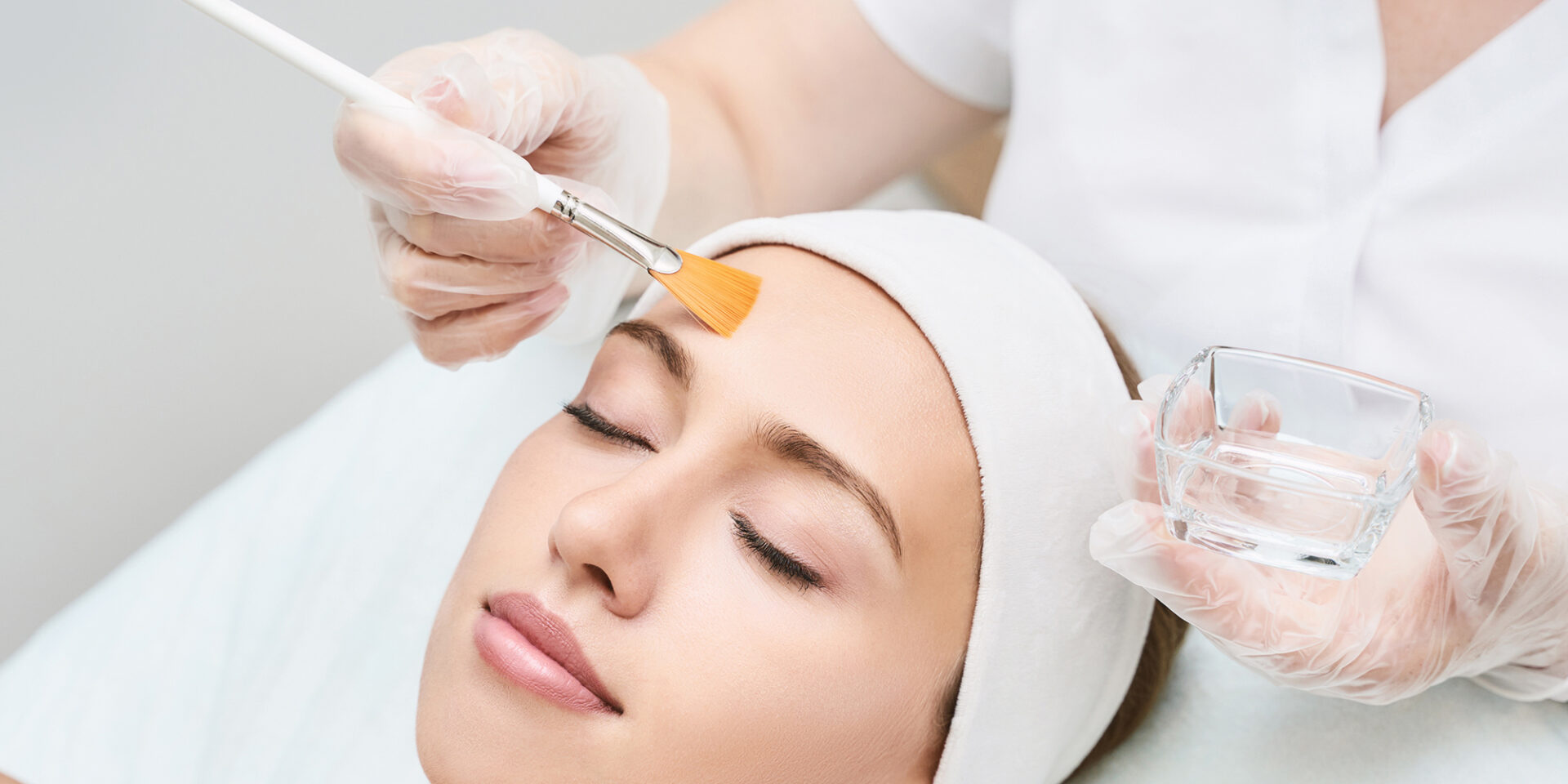 Cosmetology beauty procedure. Young woman skin care. Beautiful female person. Rejuvenation treatment. Facial chemical peel therapy. Clinical healthcare. Doctor hand. Dermatology cleanser.